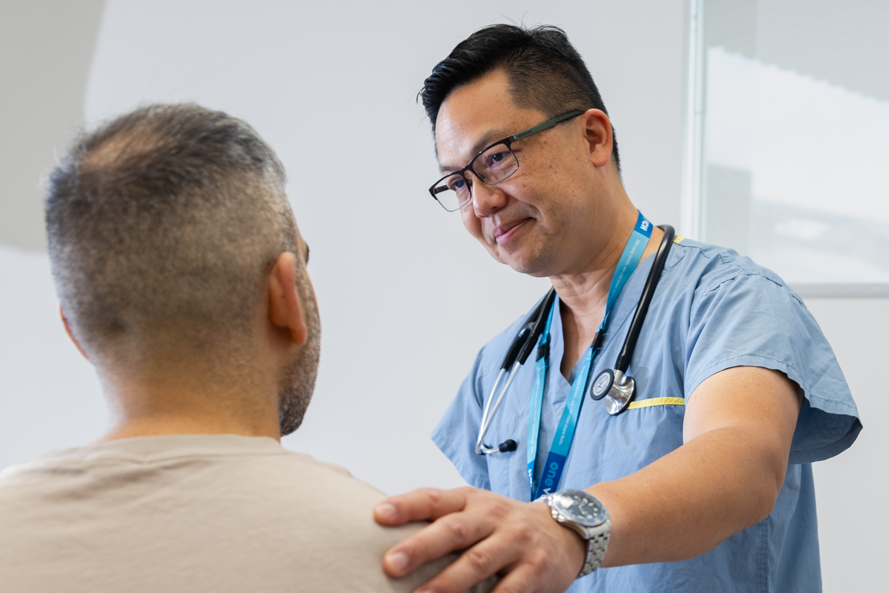 Physician has his hand on patient shoulder 