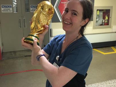 Sarah Morin, Registered Nurse, standing and holding a trophy.