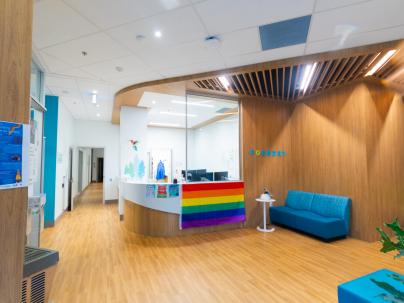 Reception area at Foundry Richmond. There is a large rainbow Pride flag hung at the reception desk.