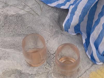 Drinking cups on the sand at the beach