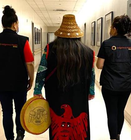 Three Indigenous Patient Navigators walking down a hallway at Vancouver General Hospital 